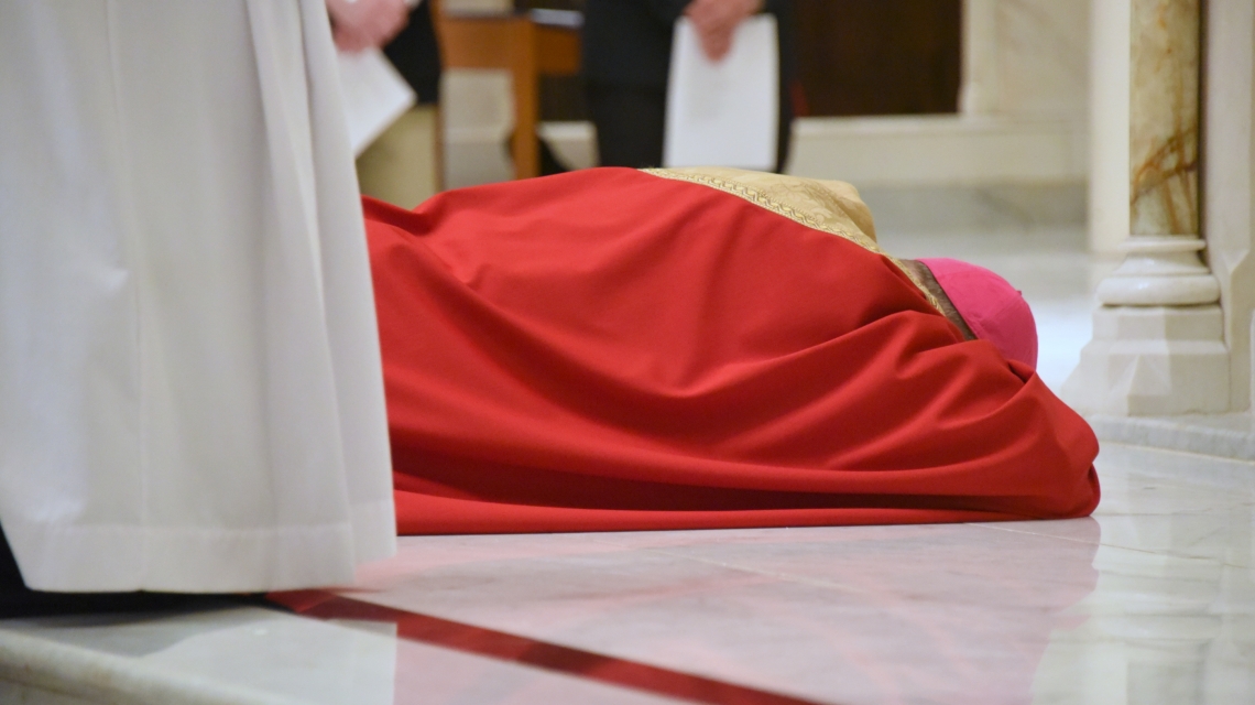 Bishop Deeley lying prostrate