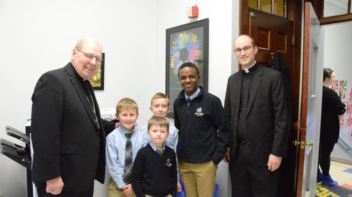 Two priests with four students