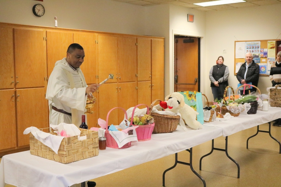 Father Joseph Osunde blesses Easter baskets.