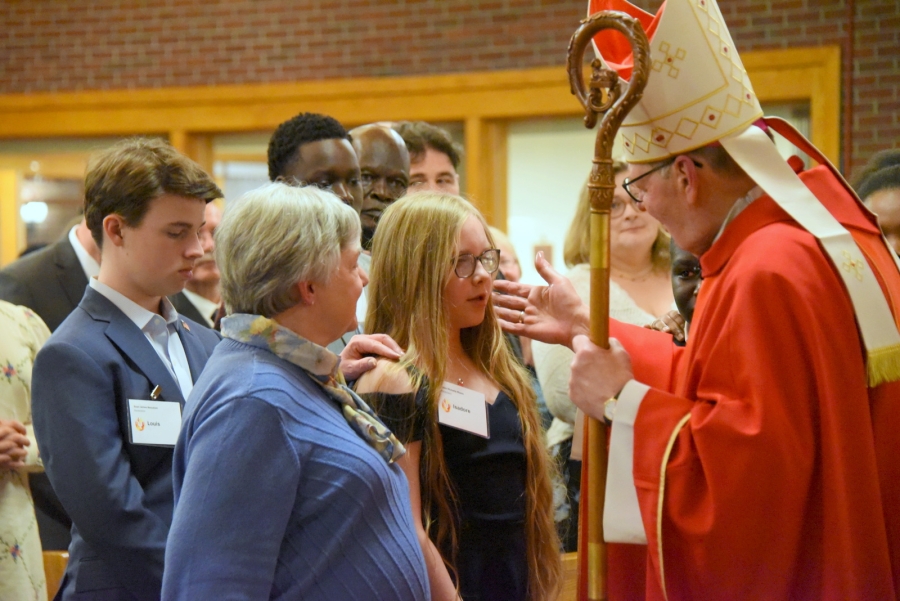 Bishop Deeley offers the sacrament of confirmation to an individual.