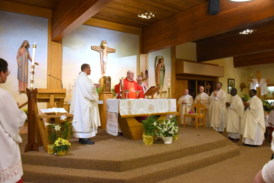 Liturgy of the Eucharist with the priests standing near the sanctuary.