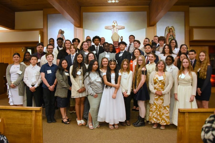 All the newly confirmed pose with the bishop.