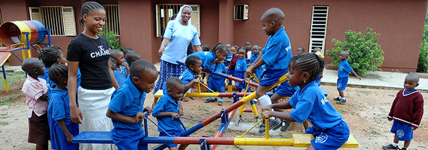 Daughter of the Holy Spirit playing on playground with kids