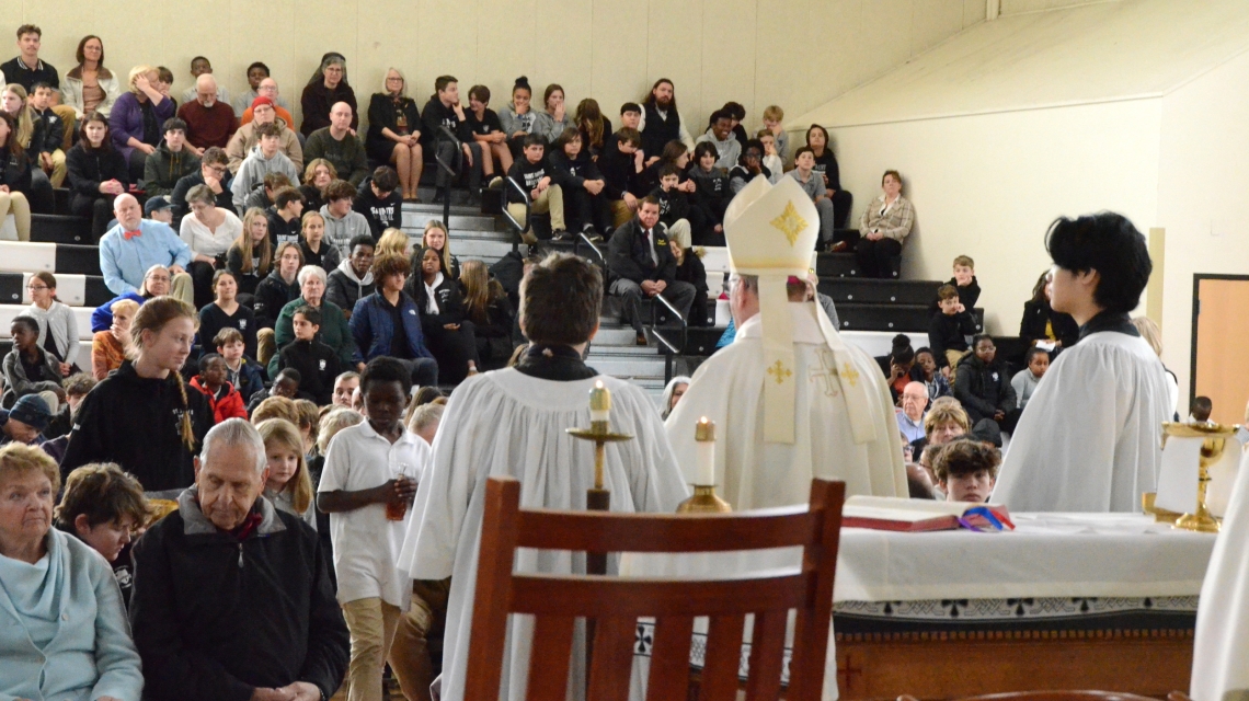Bishop and altar servers face the crowd at the mass 