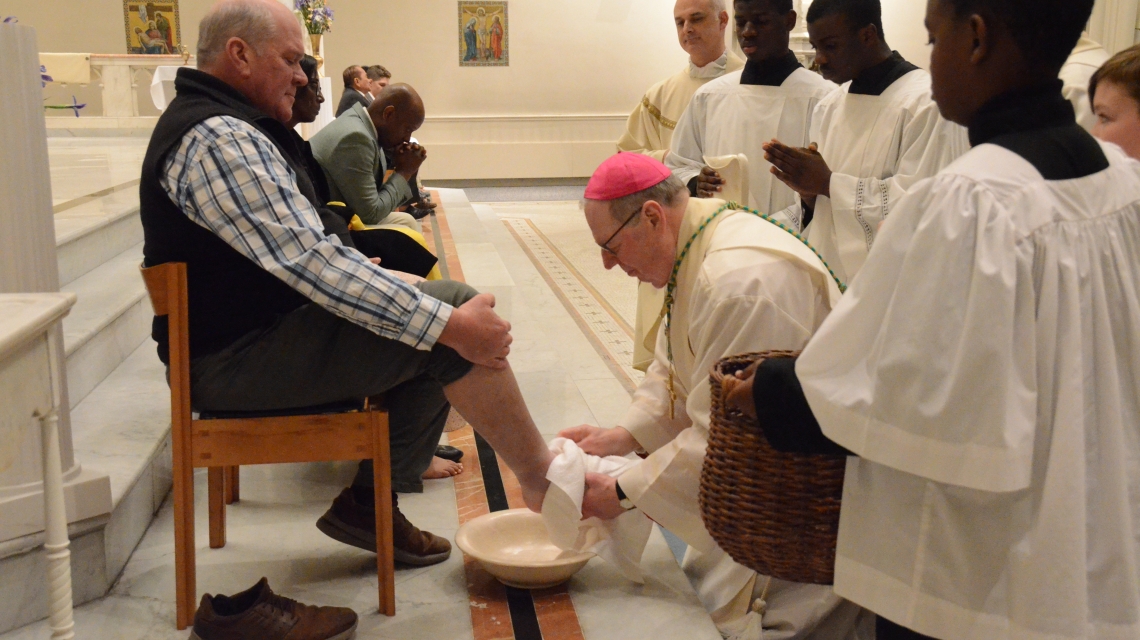 priest washes feet of a man