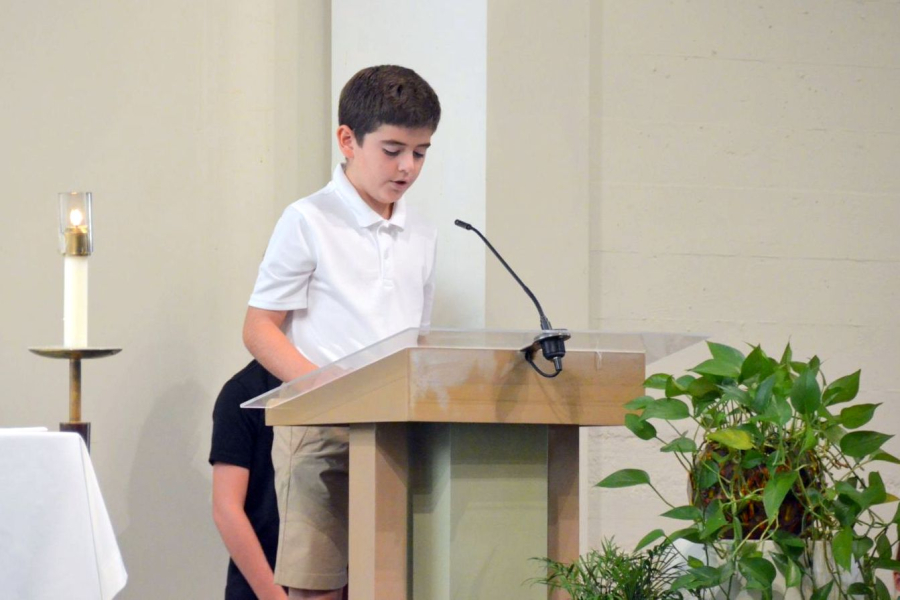 Student does a reading at the St. Dominic Academy opening Mass