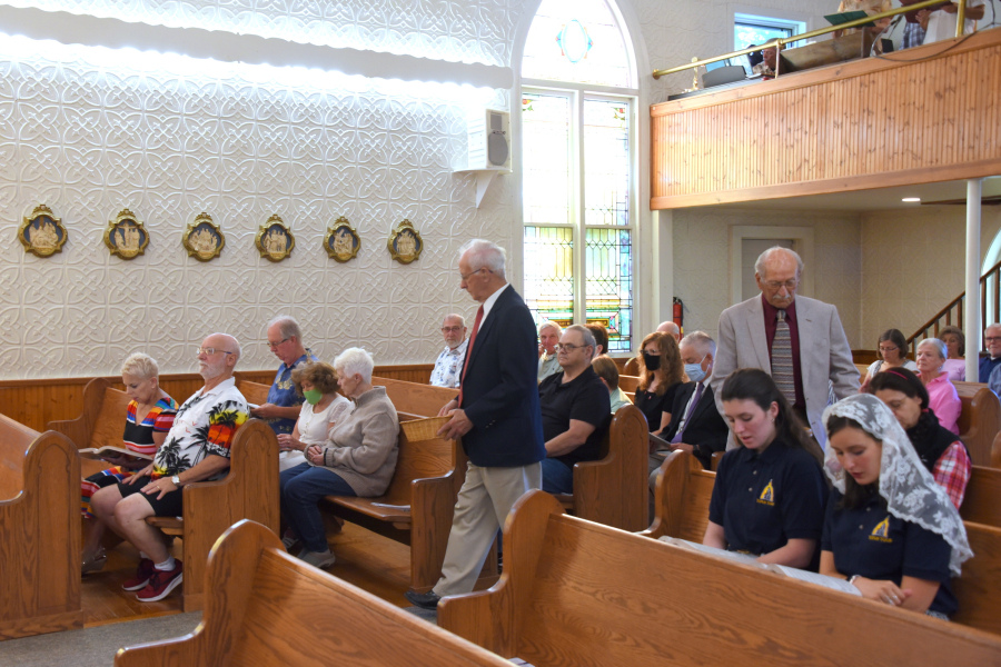 Reggie and John Rancourt take up the offertory collection at St. Gabriel Church in Winterport.