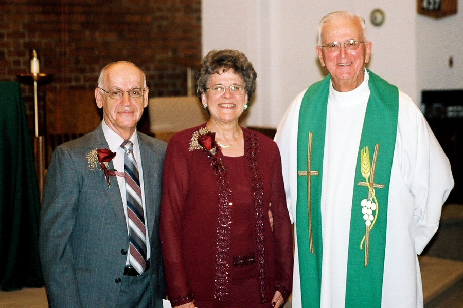 Jeannine and Eddie DeRosby with Father Paul Pare on their 50th wedding anniversary.
