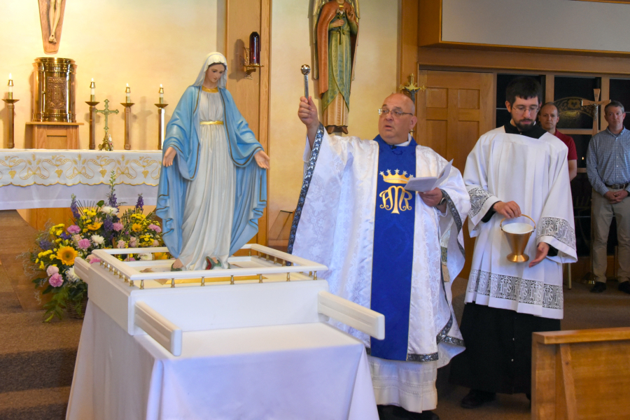Father Paul Marquis blesses statue of Mary
