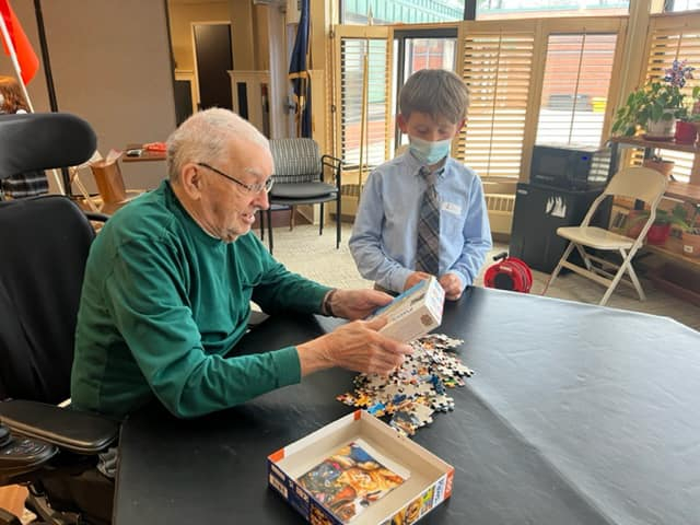 Holy Cross students in South Portland meet their veteran pen pals. 