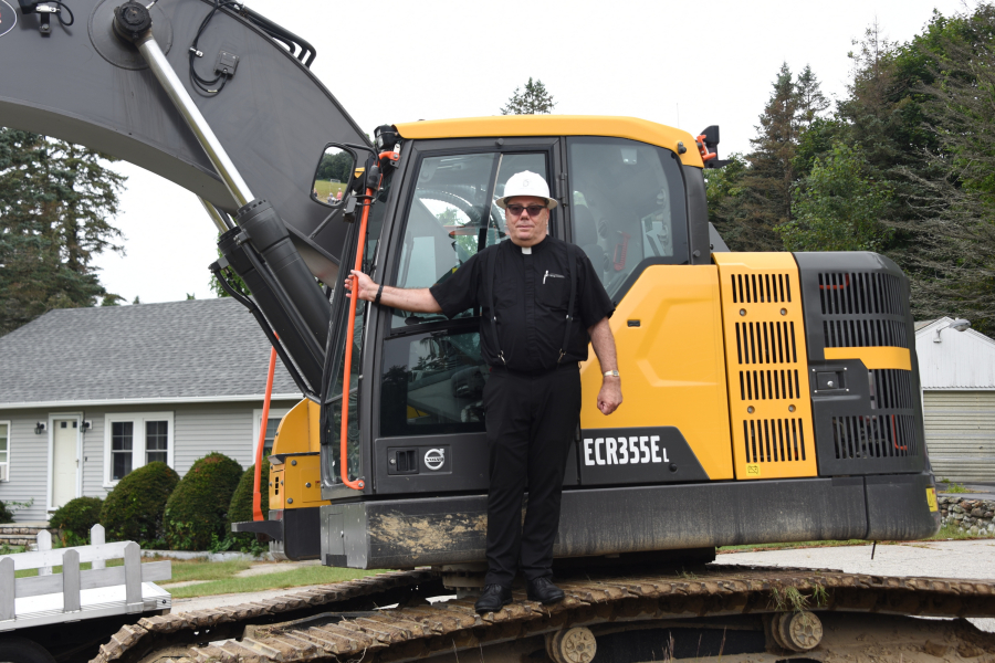 Father Labbe on bulldozer