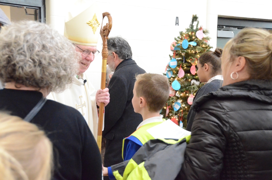 The bishop greets students and families after the mass