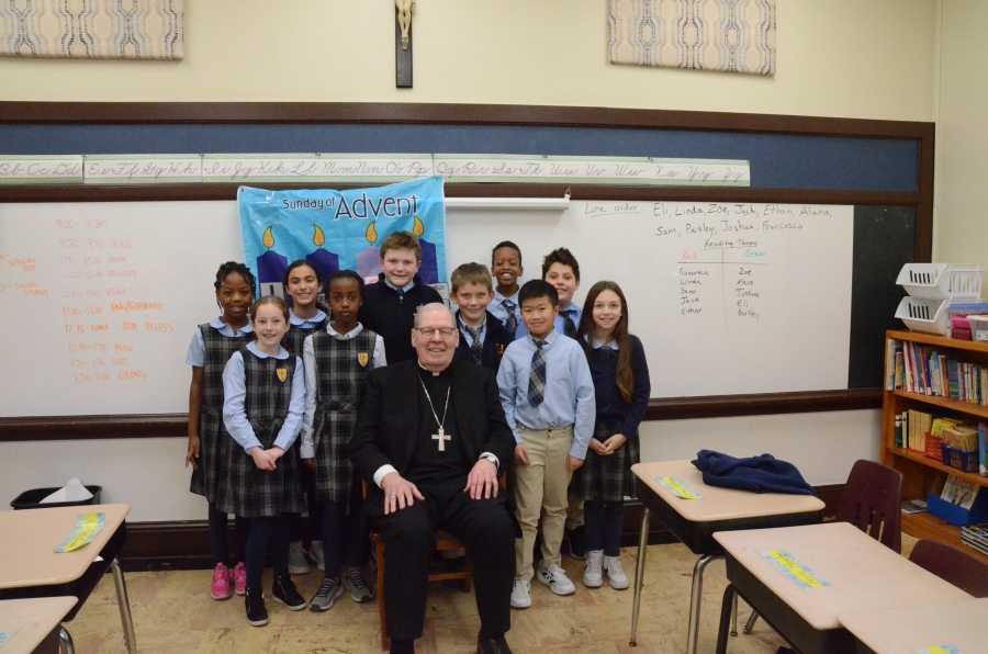 Ten students surround seated bishop 